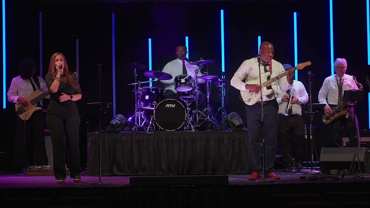 Dean St Hillaire and Friends performing on stage at an event