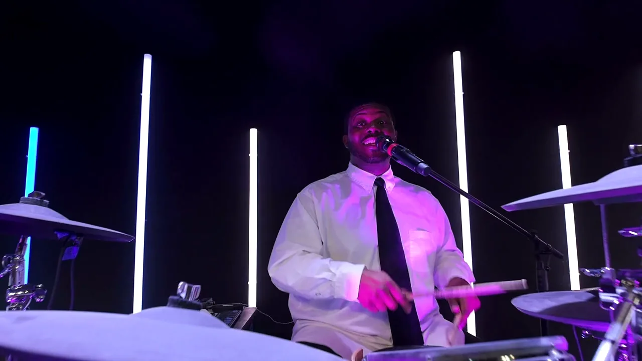 A vocalist at the microphone during a live set