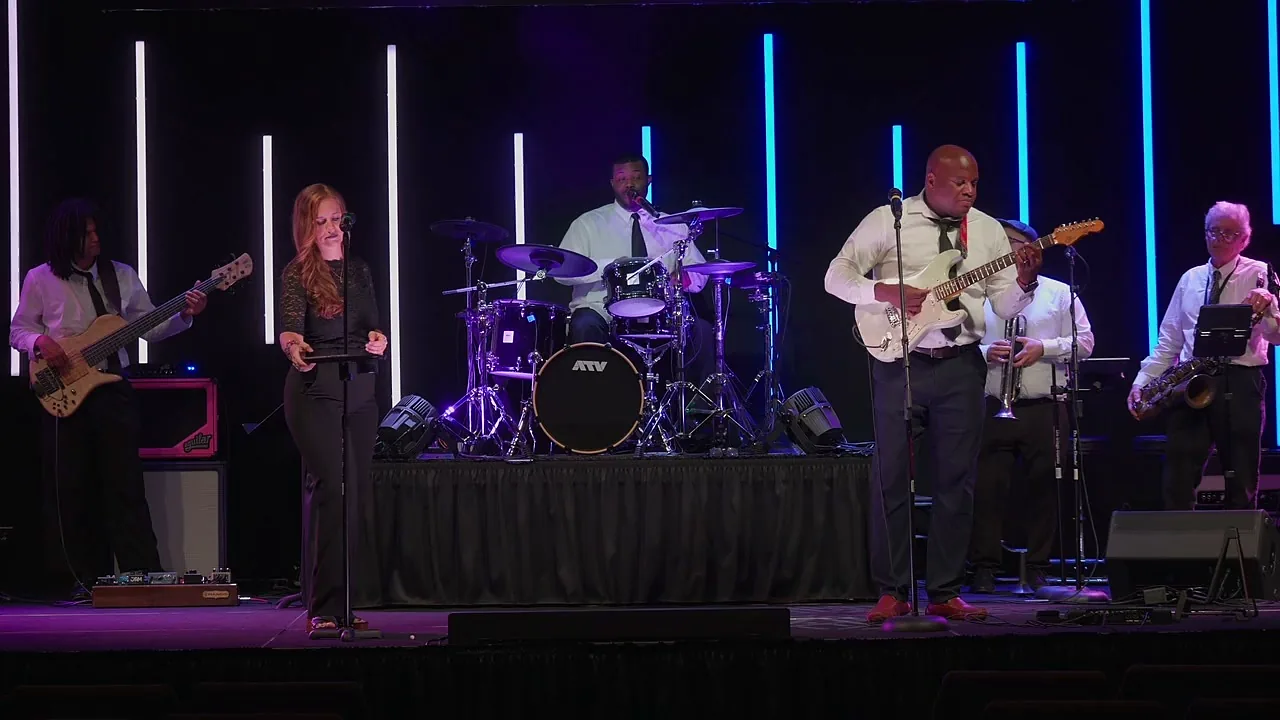 The full nine piece band on stage during a live set