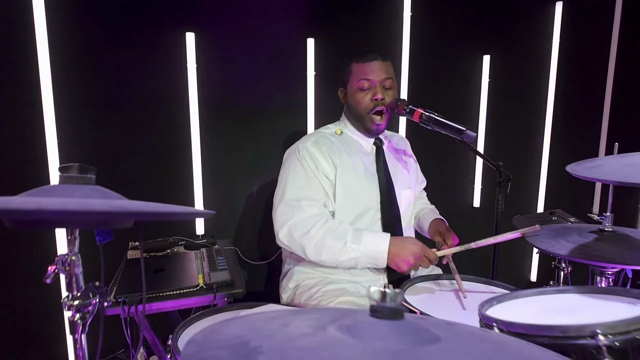 The drummer singing lead during a live set