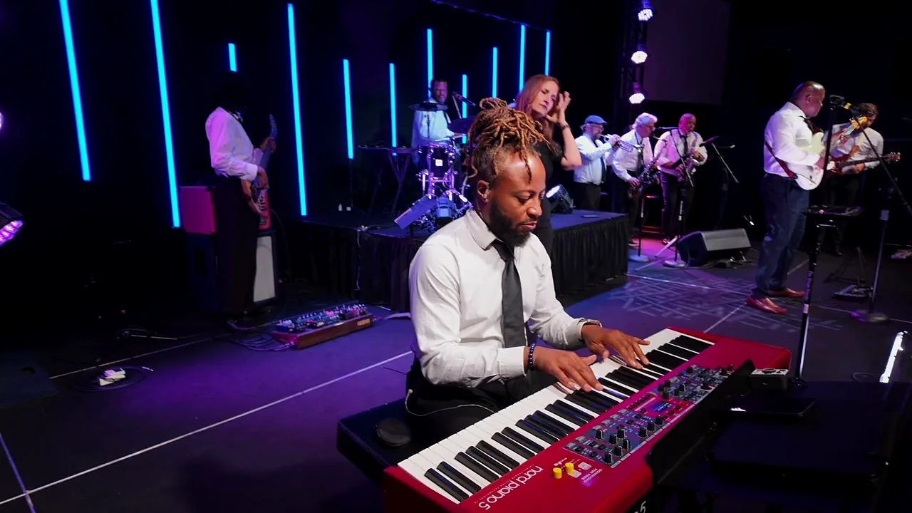 Keys player on a Nord Piano during a live set